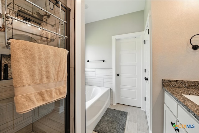 15933 Salado Dr, Temple, TX 76502 - full bathroom with a garden tub, vanity, and a stall shower