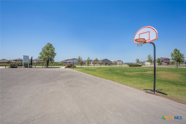 view of sport court featuring community basketball court, a yard, and a residential view