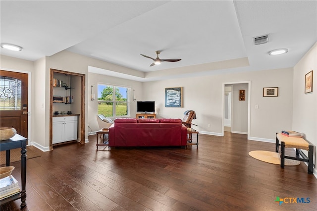 1975 Taylorsville Rd, Red Rock, TX 78662 - living area with a raised ceiling, visible vents, a ceiling fan, and dark wood-style floors