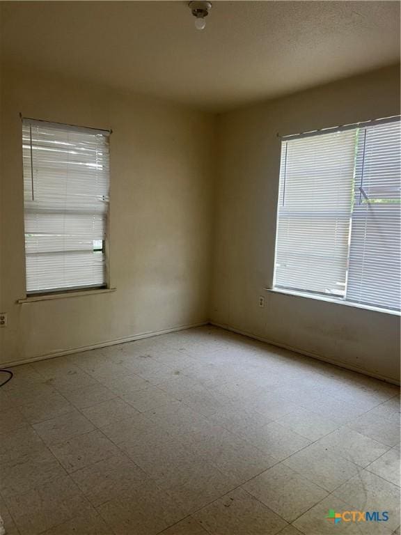 410 Railroad St, San Marcos, TX 78666 - unfurnished room featuring plenty of natural light and tile patterned floors