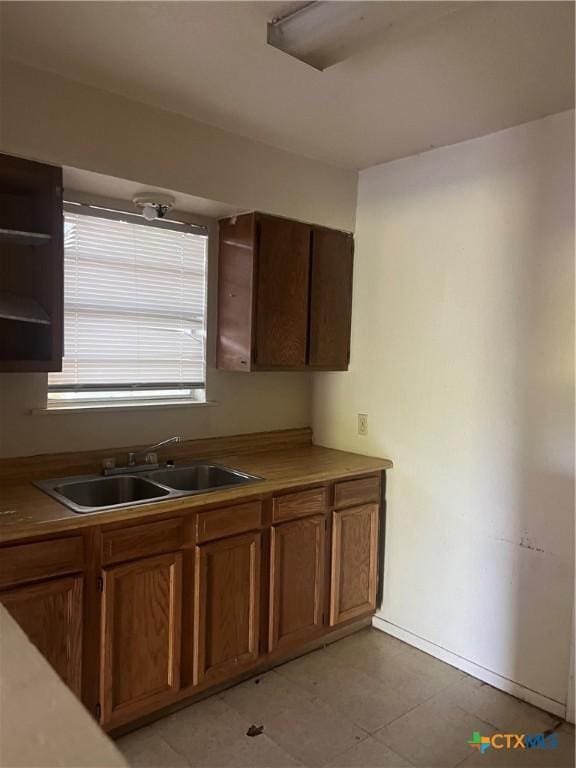 410 Railroad St, San Marcos, TX 78666 - kitchen featuring open shelves and brown cabinetry