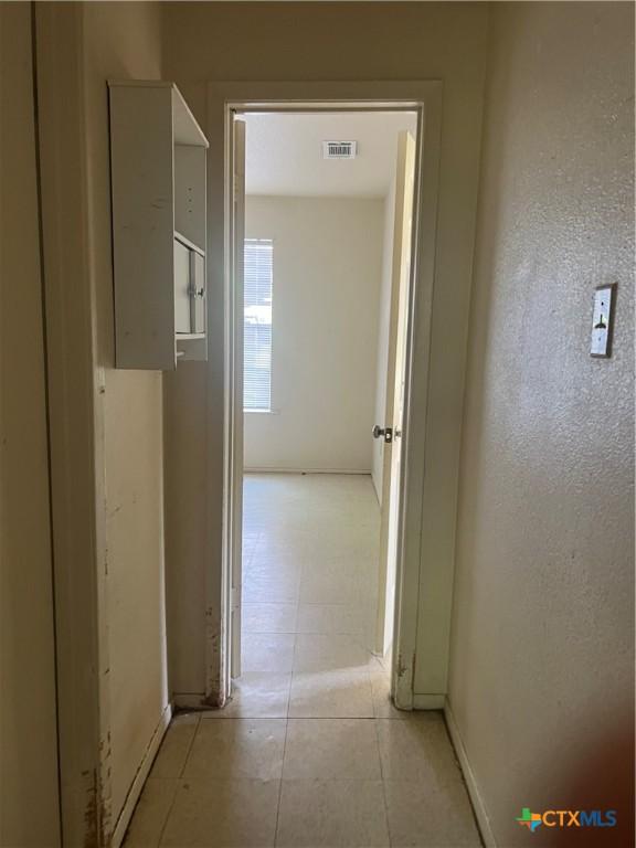 410 Railroad St, San Marcos, TX 78666 - hallway featuring baseboards and light tile patterned flooring