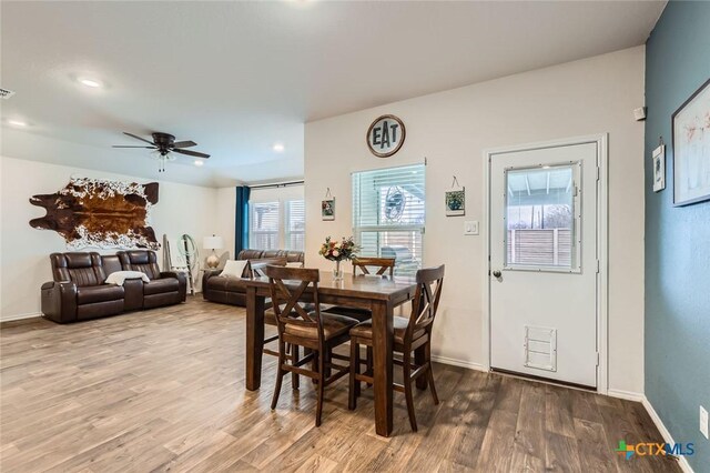 dining space with wood finished floors, baseboards, and ceiling fan