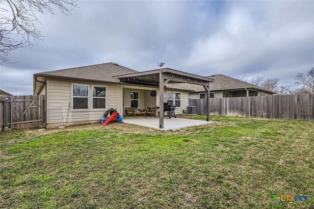 rear view of property featuring central air condition unit, roof with shingles, a lawn, a fenced backyard, and a patio area