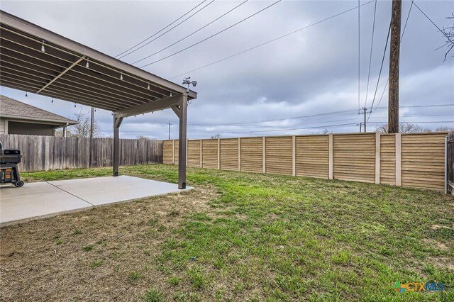 view of yard with a patio and fence