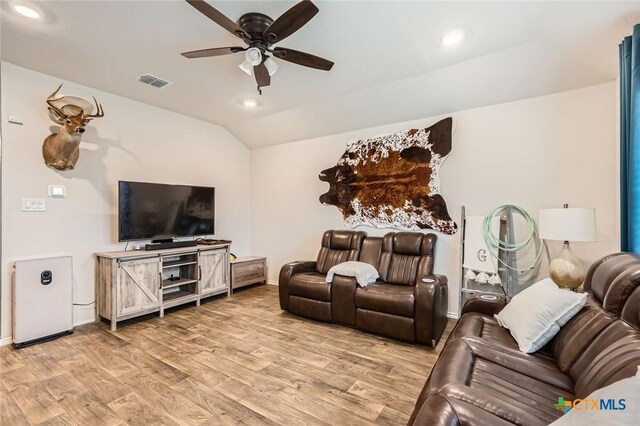 living area with a ceiling fan, visible vents, light wood-style flooring, recessed lighting, and vaulted ceiling