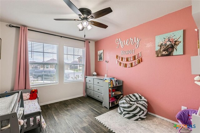 bedroom with dark wood-type flooring, a ceiling fan, and baseboards