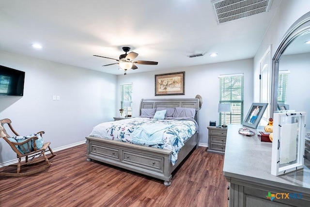 bedroom with dark hardwood / wood-style floors and ceiling fan