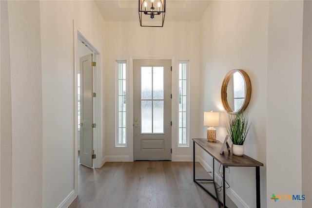 entryway featuring a chandelier and light wood-type flooring