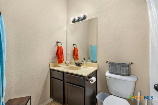 bathroom featuring vanity and toilet