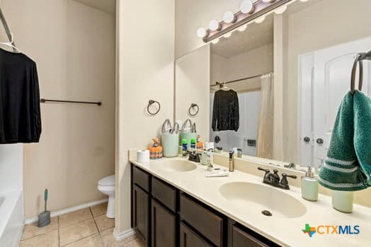 full bathroom with toilet, vanity, tile patterned flooring, and separate shower and tub