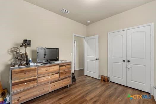 bedroom featuring dark hardwood / wood-style floors and a closet