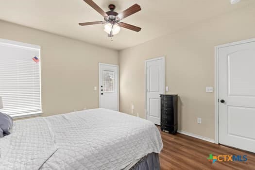 bedroom featuring ceiling fan and dark hardwood / wood-style floors