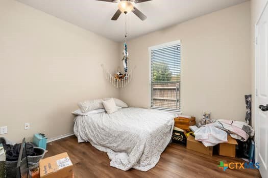 bedroom featuring dark hardwood / wood-style flooring and ceiling fan