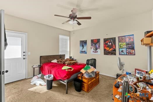 carpeted bedroom featuring ceiling fan