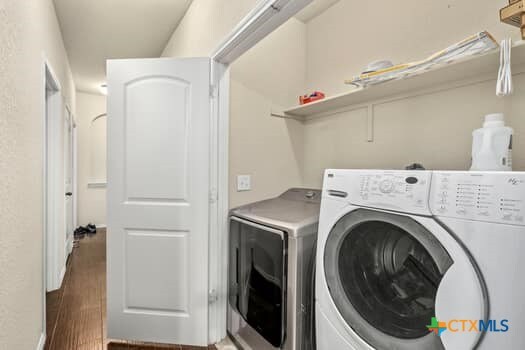 washroom featuring separate washer and dryer and dark wood-type flooring