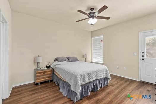 bedroom featuring dark hardwood / wood-style floors and ceiling fan