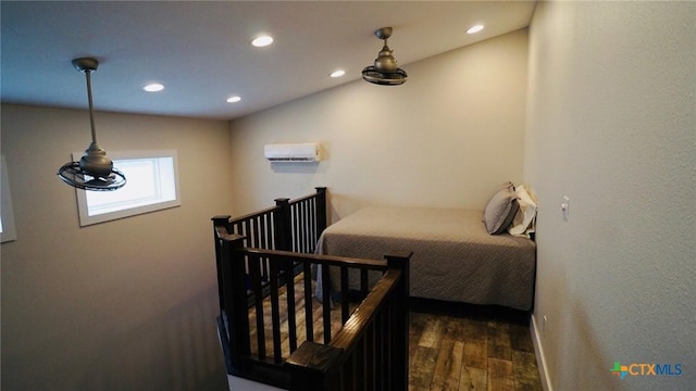 1206 W Commerce St, Port Oconnor, TX 77982 - bedroom with baseboards, recessed lighting, a wall mounted AC, and wood finished floors