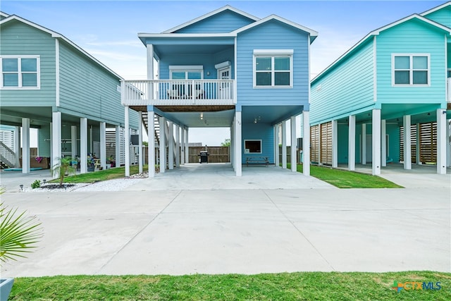 raised beach house featuring a carport