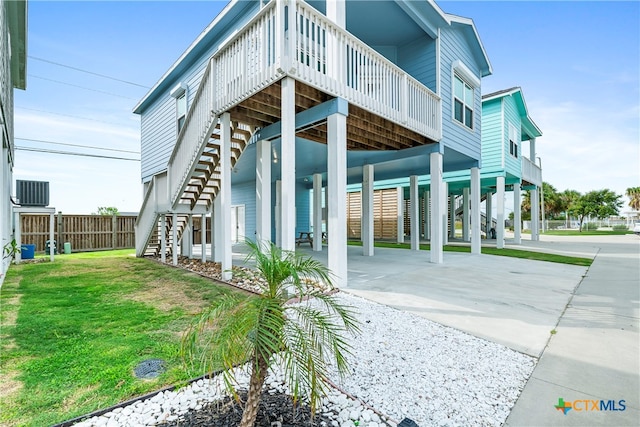 back of house with a yard and a carport