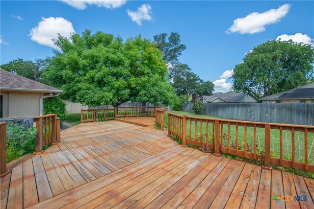 wooden deck with a lawn