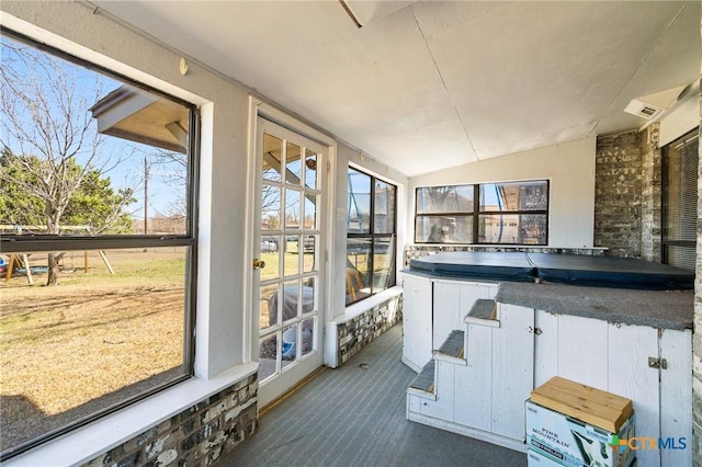 sunroom with a wealth of natural light and vaulted ceiling