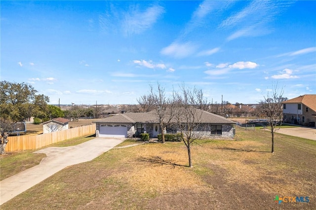 single story home with an attached garage, concrete driveway, a front yard, and fence