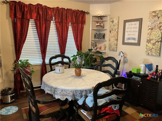 dining area with hardwood / wood-style flooring