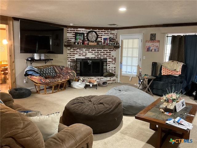 living room with a brick fireplace, carpet, and ornamental molding