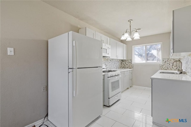 kitchen featuring white appliances, a notable chandelier, backsplash, and a sink