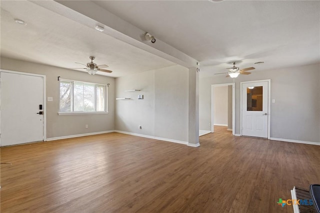 unfurnished living room with baseboards, ceiling fan, and wood finished floors