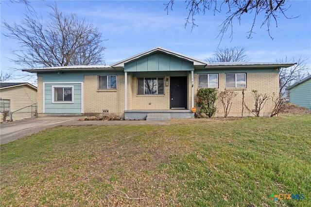 single story home with a front yard, brick siding, and metal roof