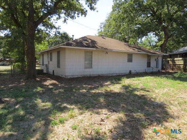 view of side of property with a lawn