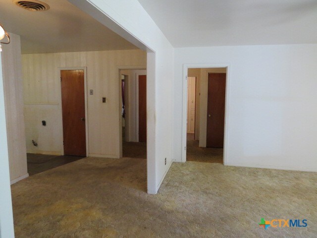 unfurnished room with light colored carpet