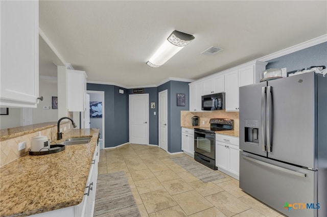 116 Bufflehead Ln, Leander, TX 78641 - kitchen with black appliances, a sink, backsplash, white cabinets, and crown molding