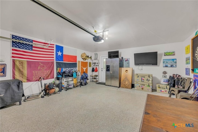 116 Bufflehead Ln, Leander, TX 78641 - garage with stainless steel fridge and a garage door opener