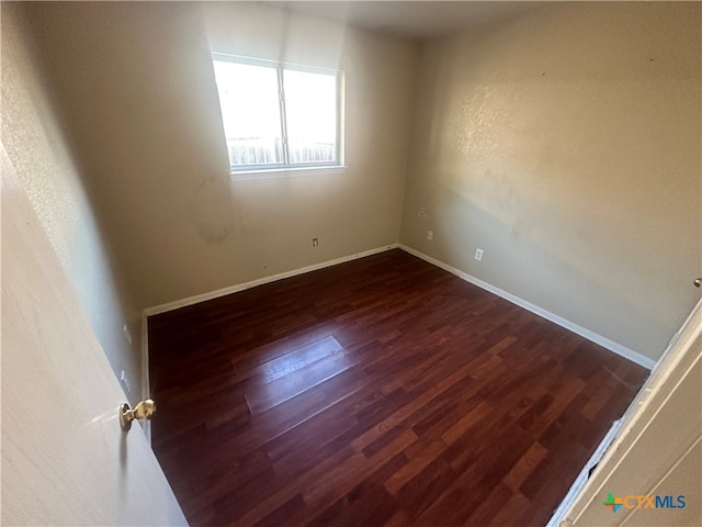 unfurnished room featuring dark hardwood / wood-style floors