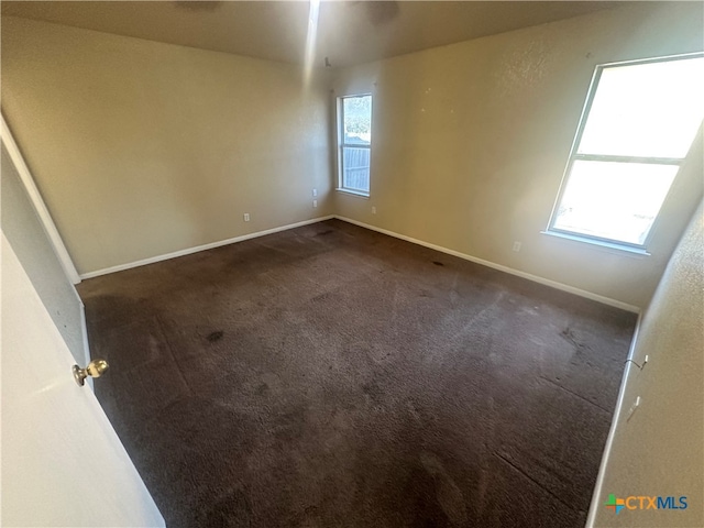 carpeted spare room with a healthy amount of sunlight