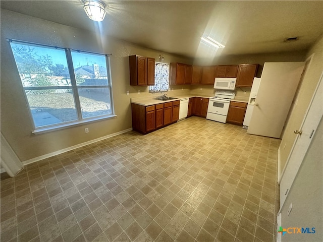 kitchen featuring white appliances and sink