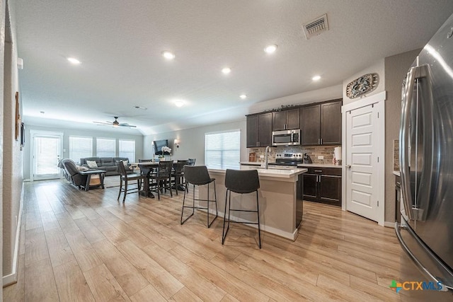3627 Twin Dish Way, New Braunfels, TX 78130 - kitchen with stainless steel appliances, open floor plan, plenty of natural light, a breakfast bar, and recessed lighting