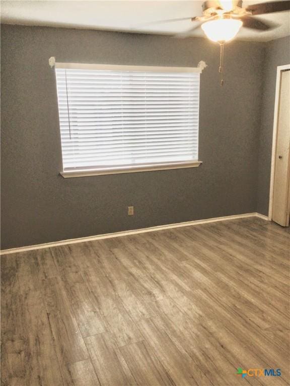 2004 Sherman Dr, Killeen, TX 76543 - empty room featuring a ceiling fan, wood finished floors, and healthy amount of natural light