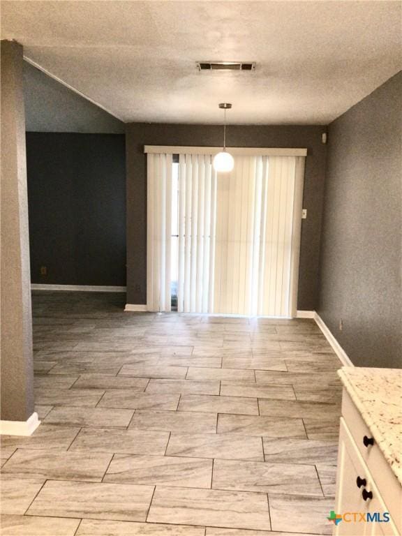 2004 Sherman Dr, Killeen, TX 76543 - unfurnished dining area featuring wood finish floors and a textured ceiling