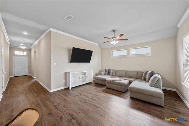 living room featuring wood finished floors, ornamental molding, a ceiling fan, and baseboards