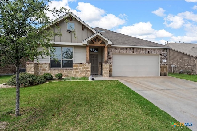 craftsman-style house featuring board and batten siding, driveway, a garage, a front lawn, and stone siding