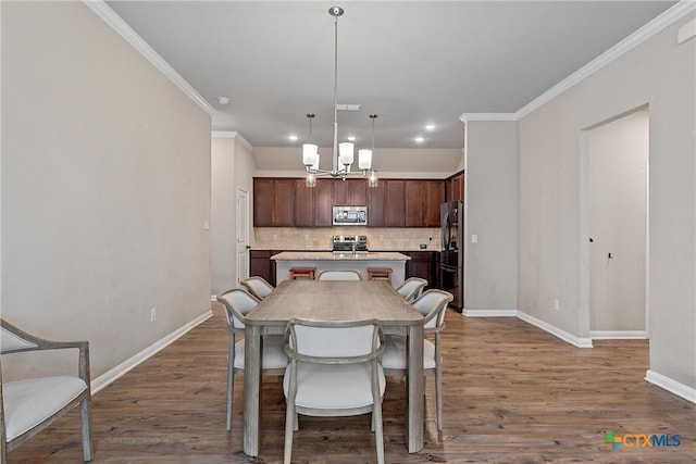 dining room featuring baseboards, a chandelier, dark wood-style flooring, ornamental molding, and recessed lighting