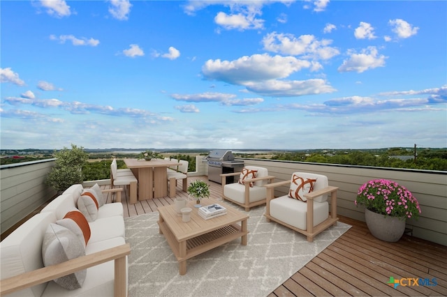 wooden terrace with area for grilling and an outdoor hangout area