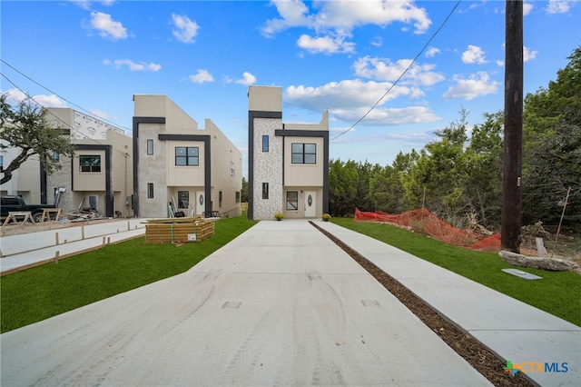 modern home featuring a front yard