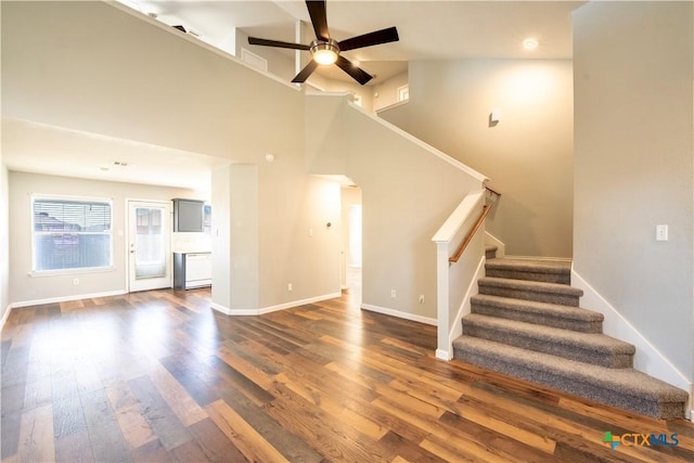 4912 Donegal Bay Ct, Killeen, TX 76549 - unfurnished living room featuring stairs, dark wood finished floors, ceiling fan, and a high ceiling