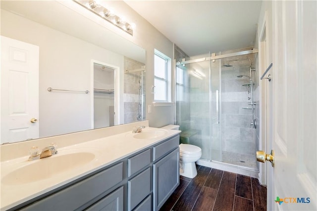 4912 Donegal Bay Ct, Killeen, TX 76549 - bathroom featuring a shower stall, double vanity, and wood finished floors