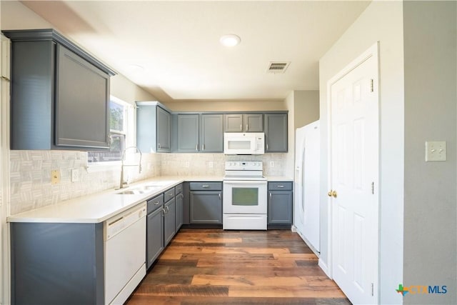 4912 Donegal Bay Ct, Killeen, TX 76549 - kitchen featuring white appliances, gray cabinets, tasteful backsplash, dark wood-style floors, and light countertops